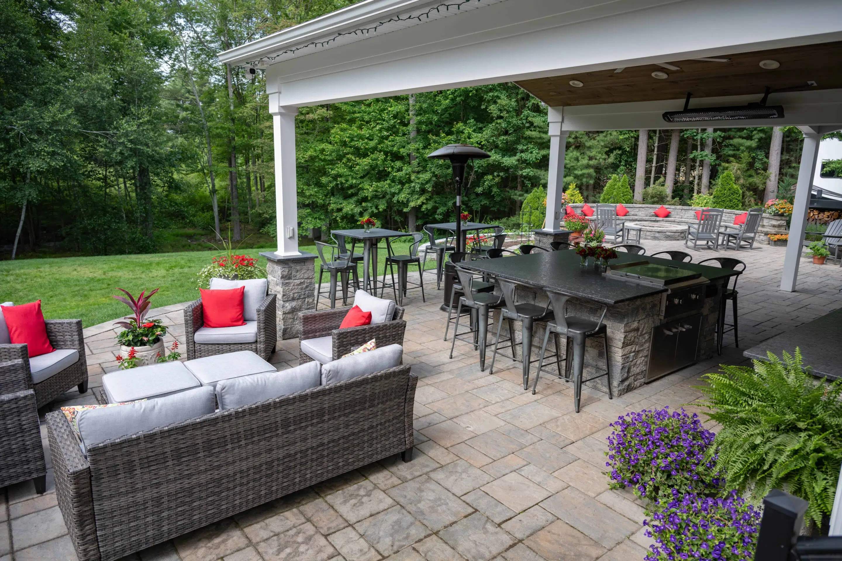 Hardscape design by Beebe Landscape Service in Somers, CT featuring a stone patio and outdoor kitchen